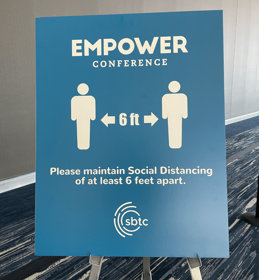 returning to in-person events safely - empower conference 6 feet apart signage